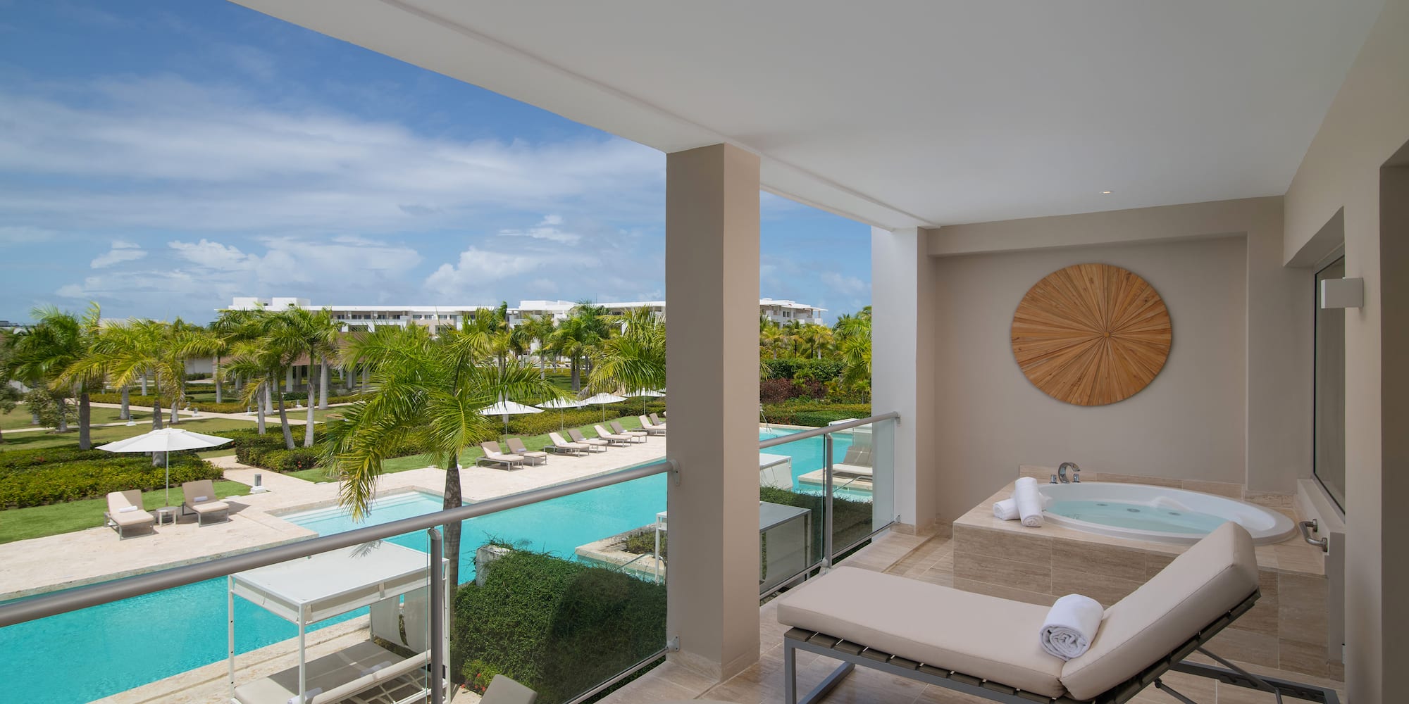 a balcony with a jacuzzi and a pool