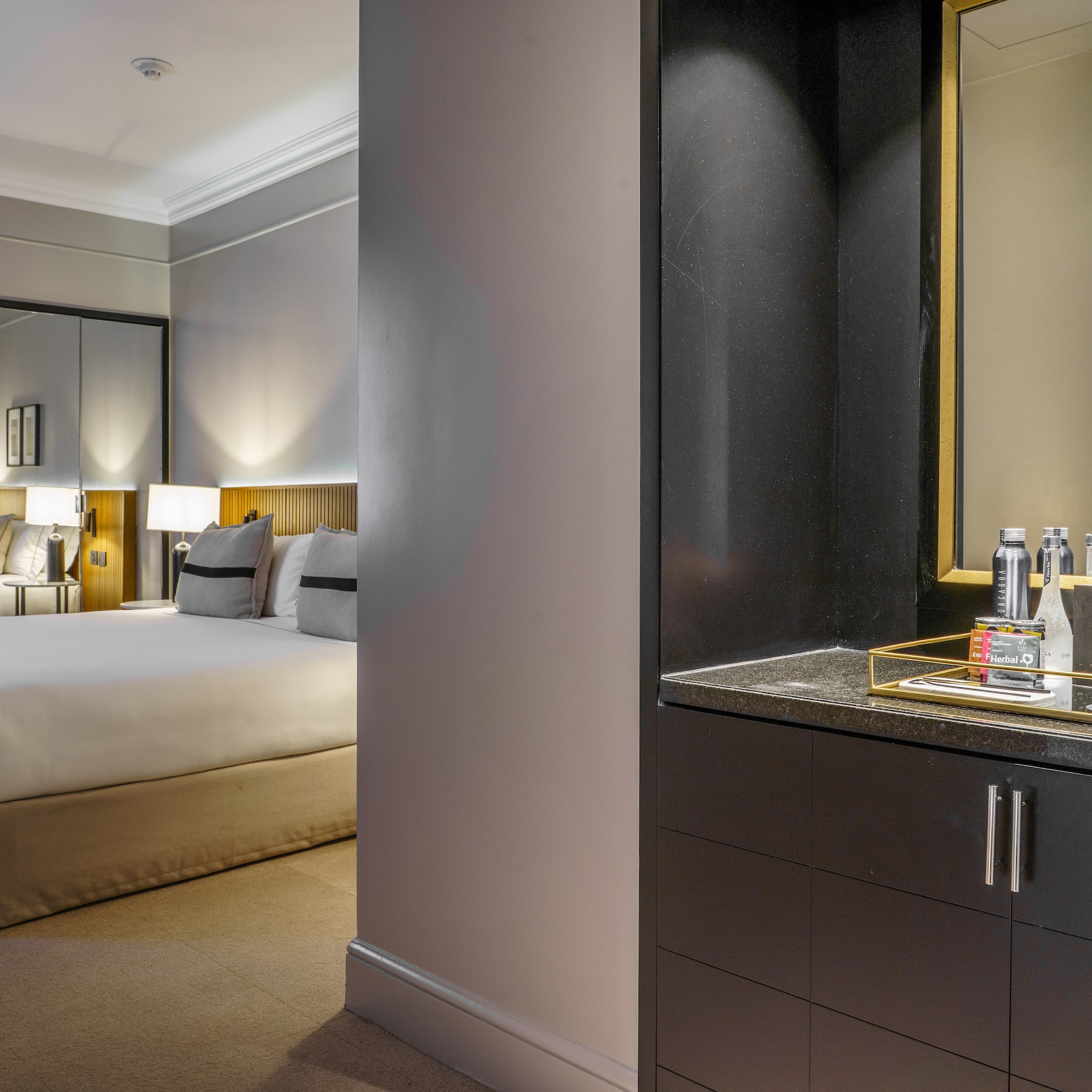 a bedroom with a mirror and a bed