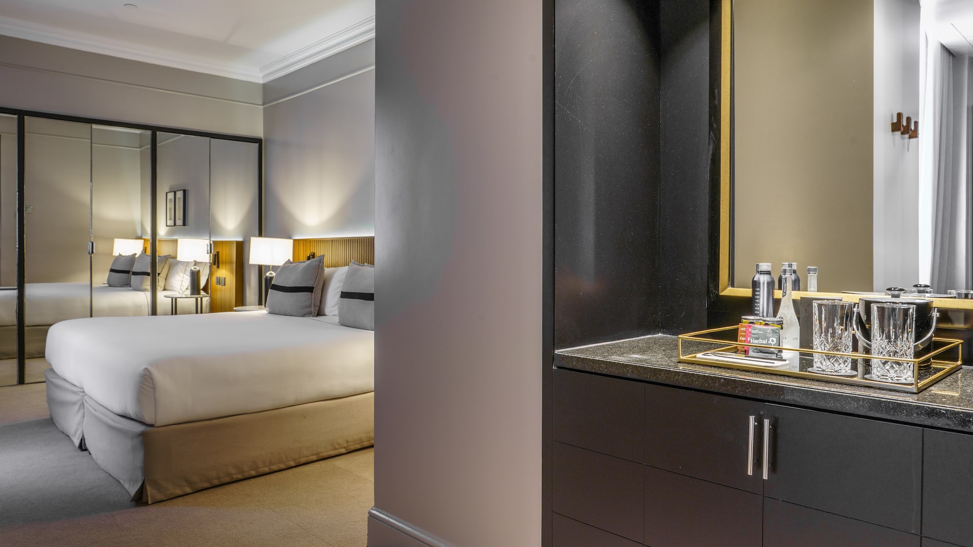 a bedroom with a mirror and a bed