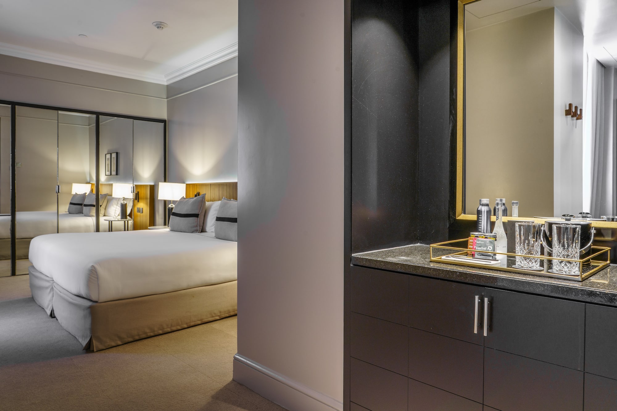 a bedroom with a mirror and a bed