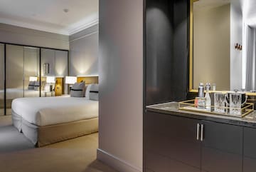 a bedroom with a mirror and a bed