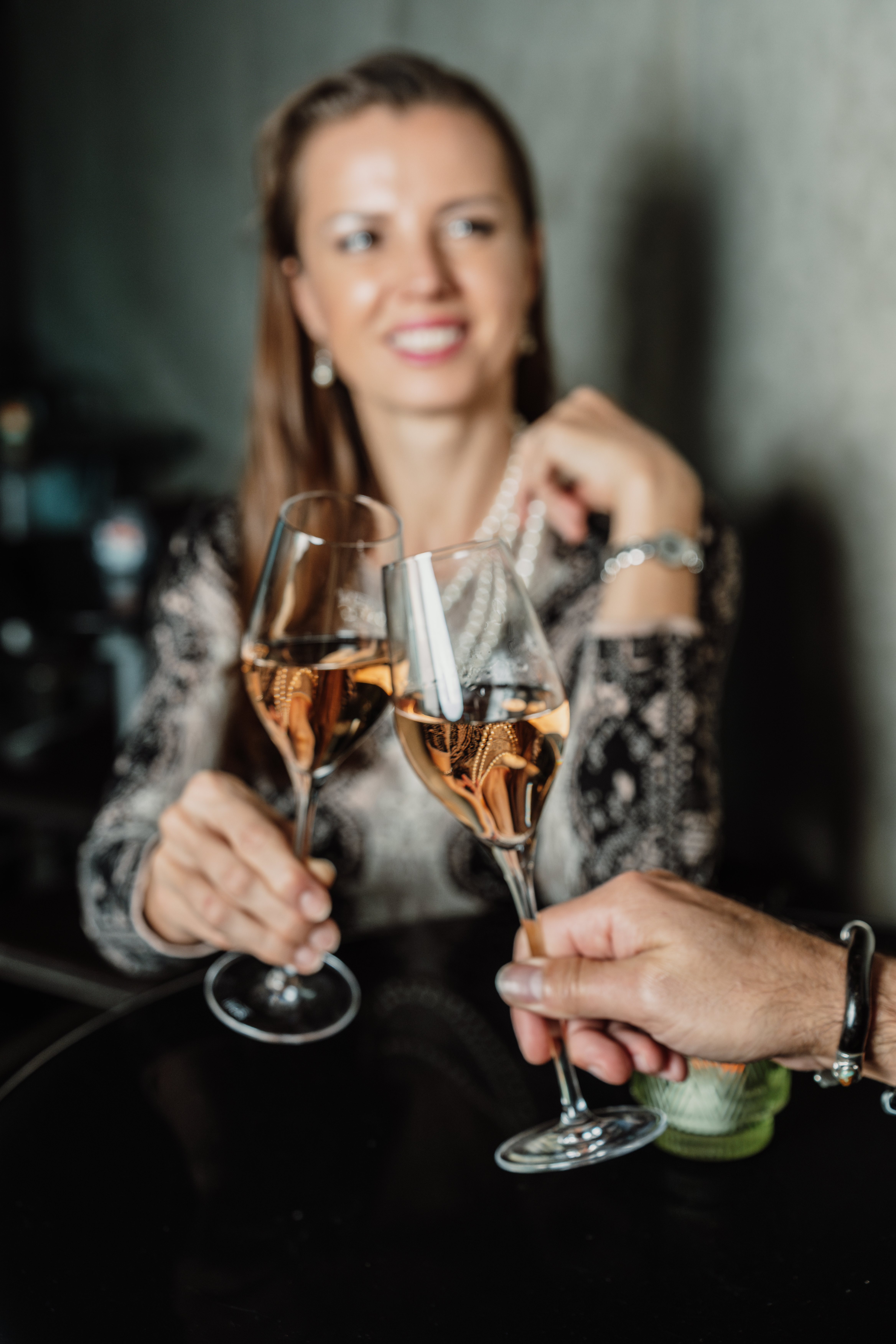 a woman holding wine glasses