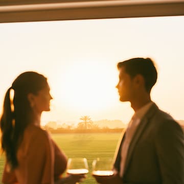 a man and woman holding wine glasses
