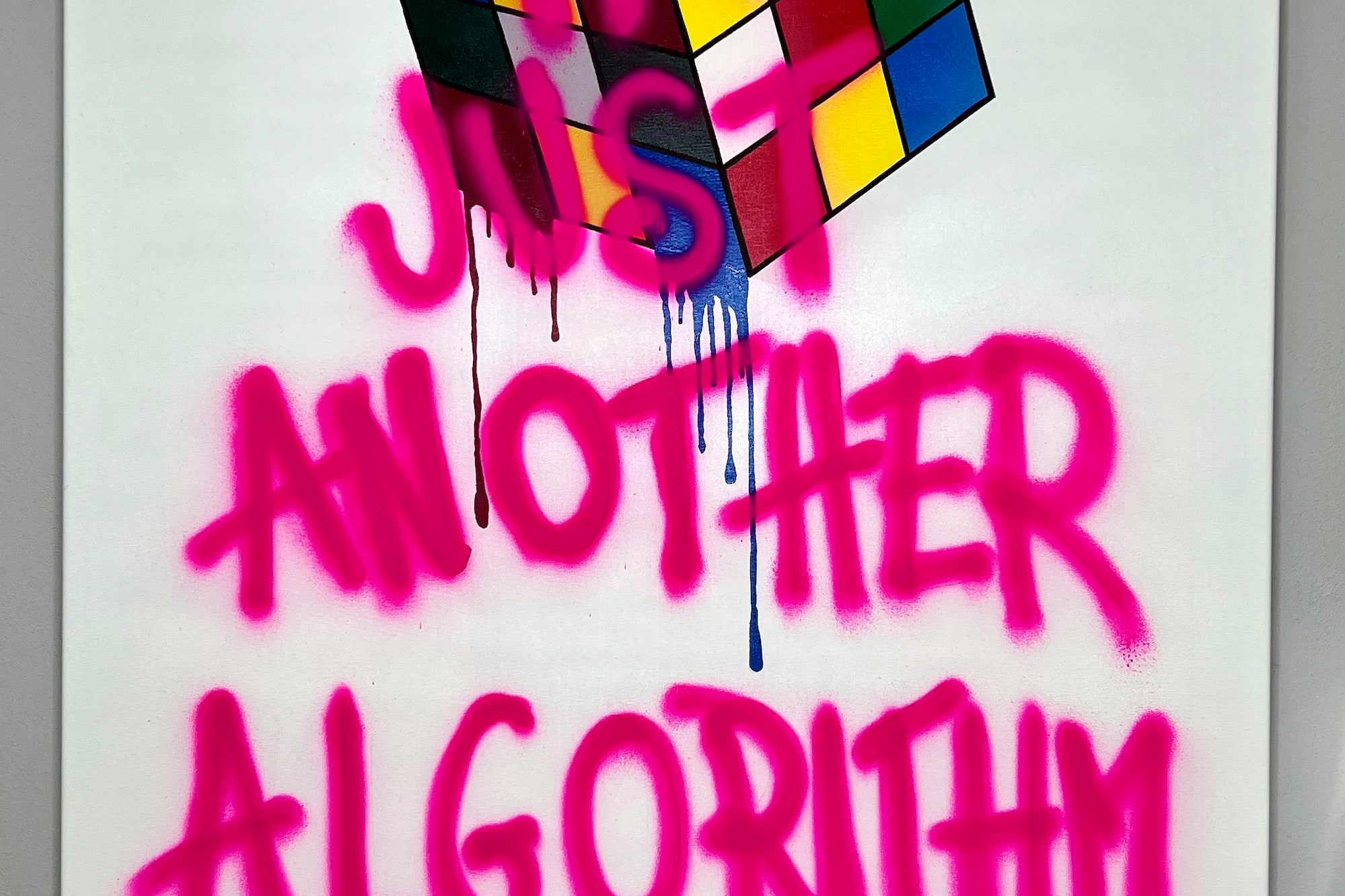 a white sign with pink writing on it