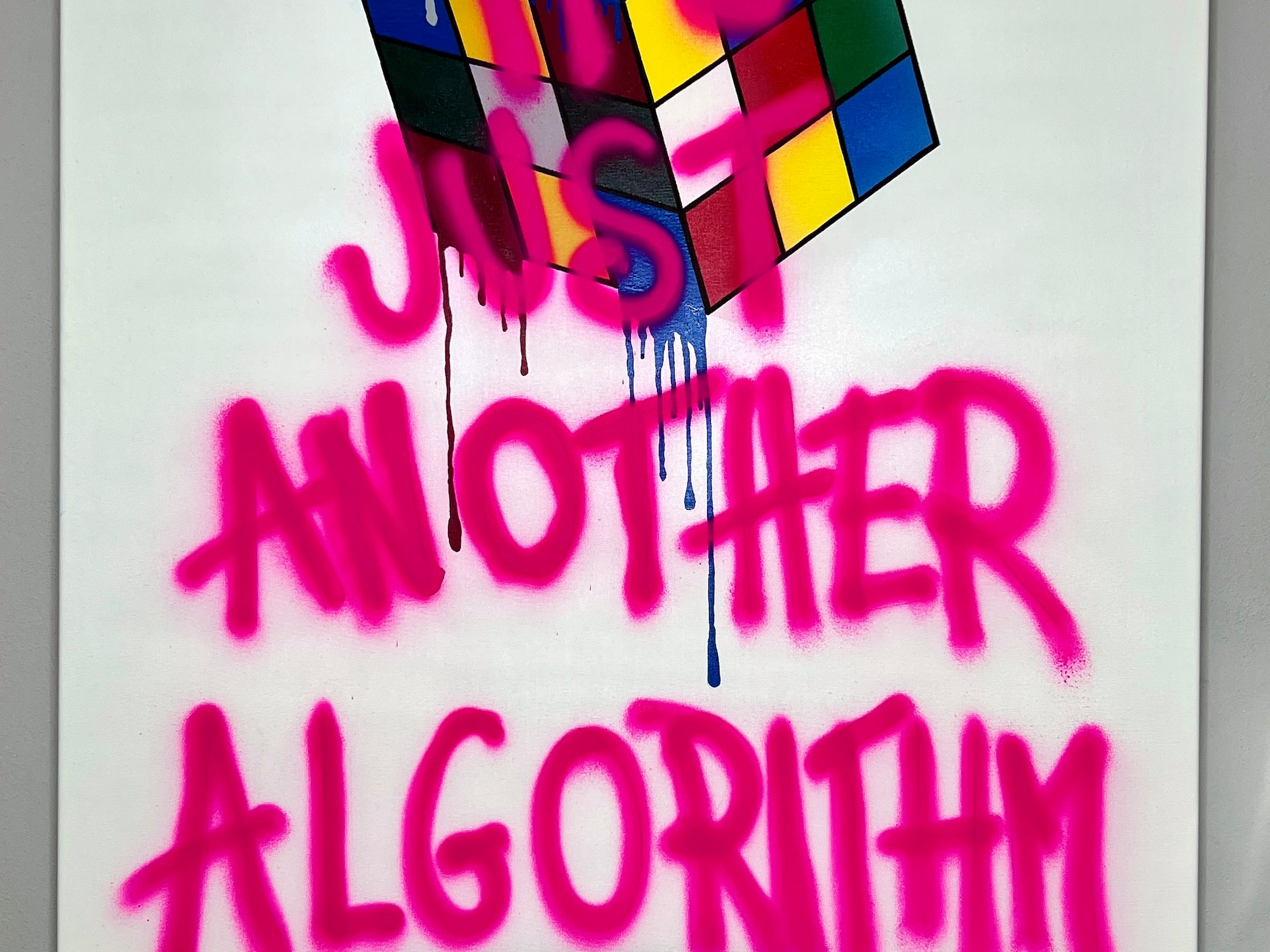 a white sign with pink writing on it