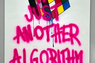a white sign with pink writing on it