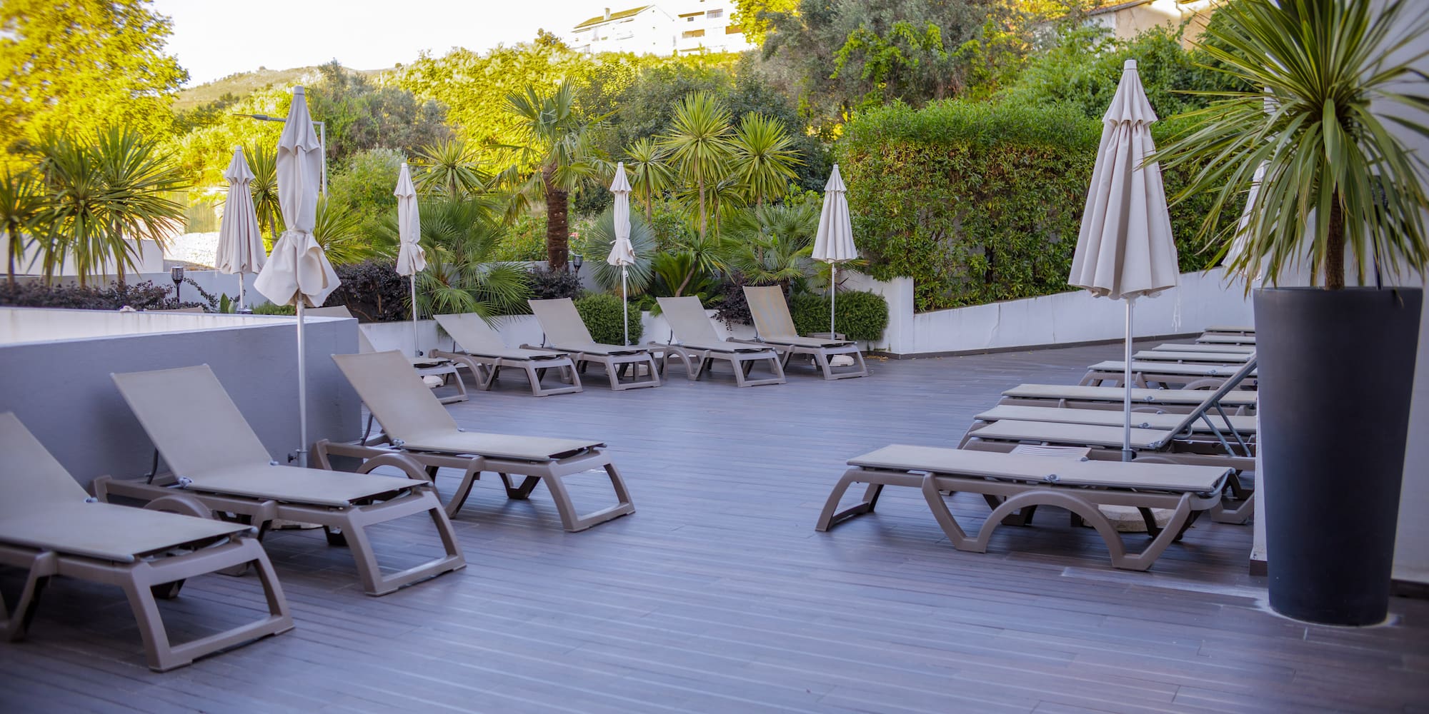 a deck with lounge chairs and umbrellas