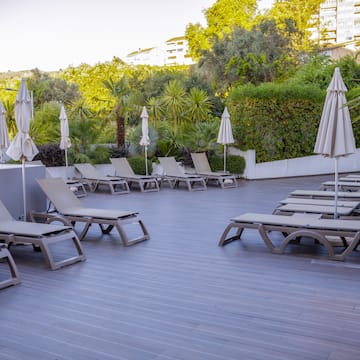 a deck with lounge chairs and umbrellas