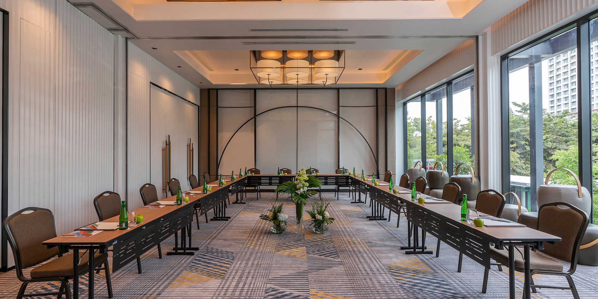 a room with long tables and chairs