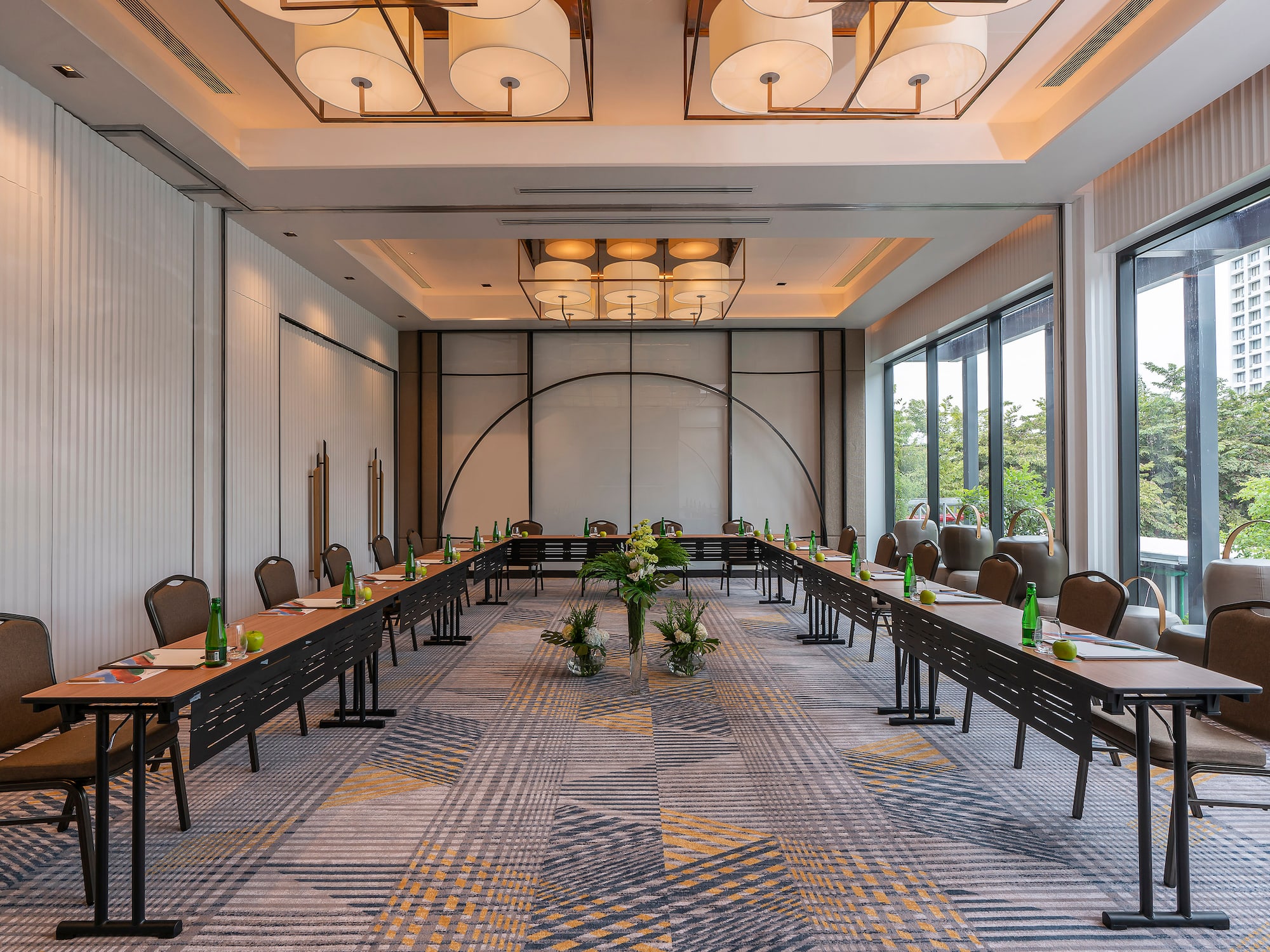 a room with long tables and chairs