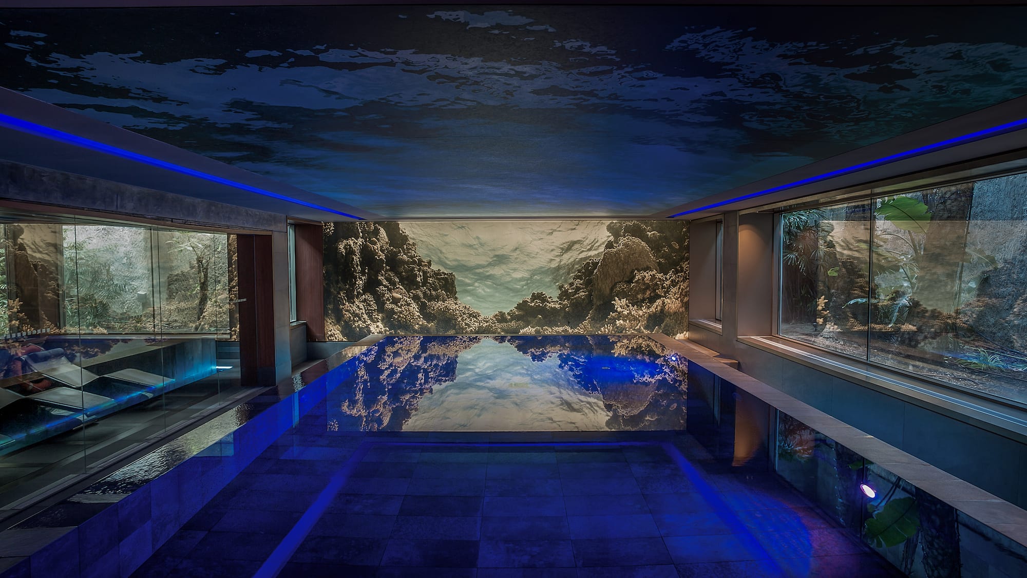 a indoor pool with a large wall mural