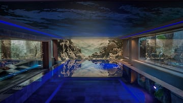 a indoor pool with a large wall mural