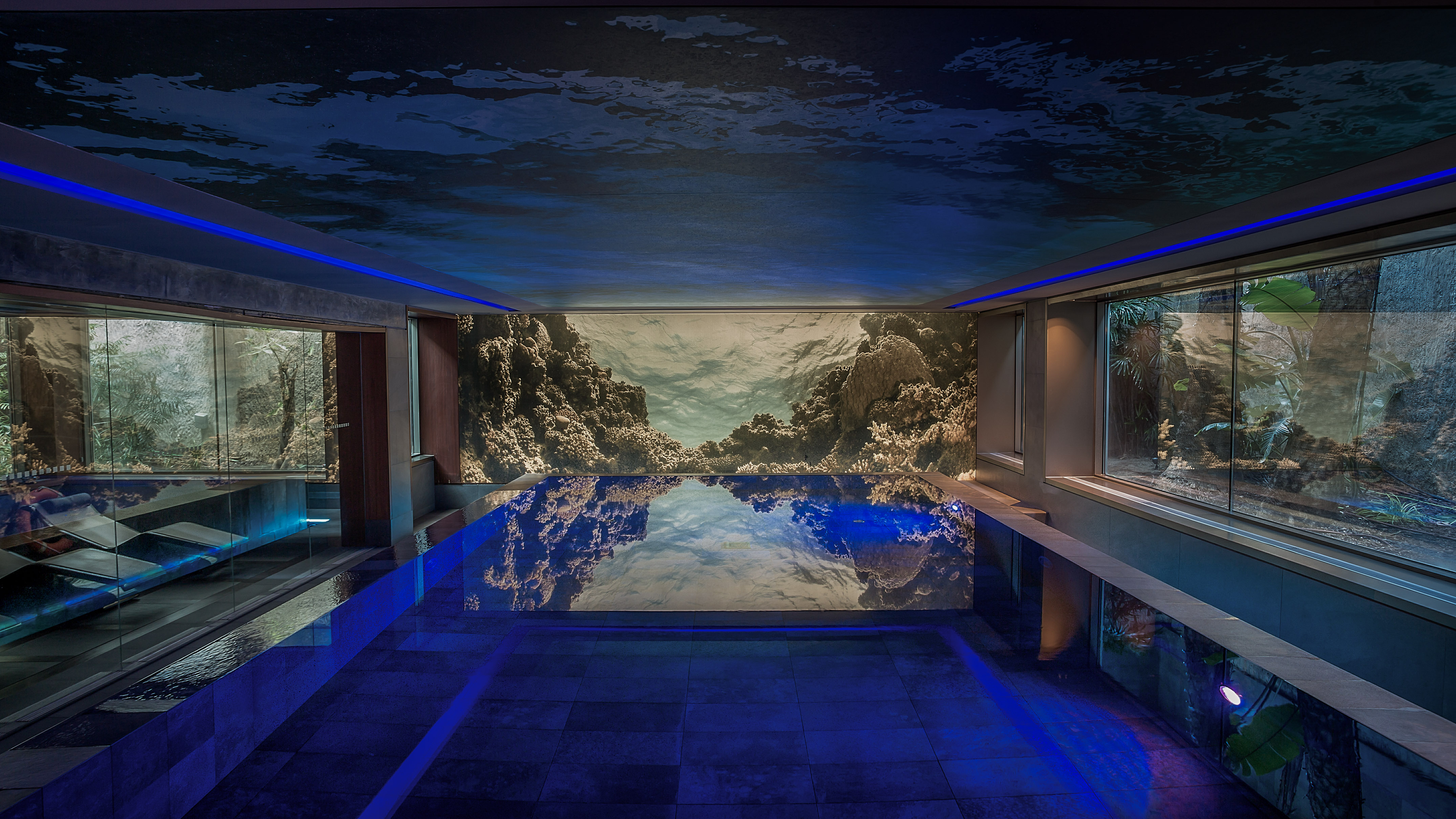 a indoor pool with a large wall mural