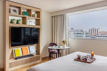 a room with a bed and a tv