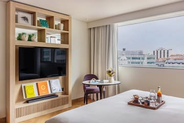 a room with a bed and a tv