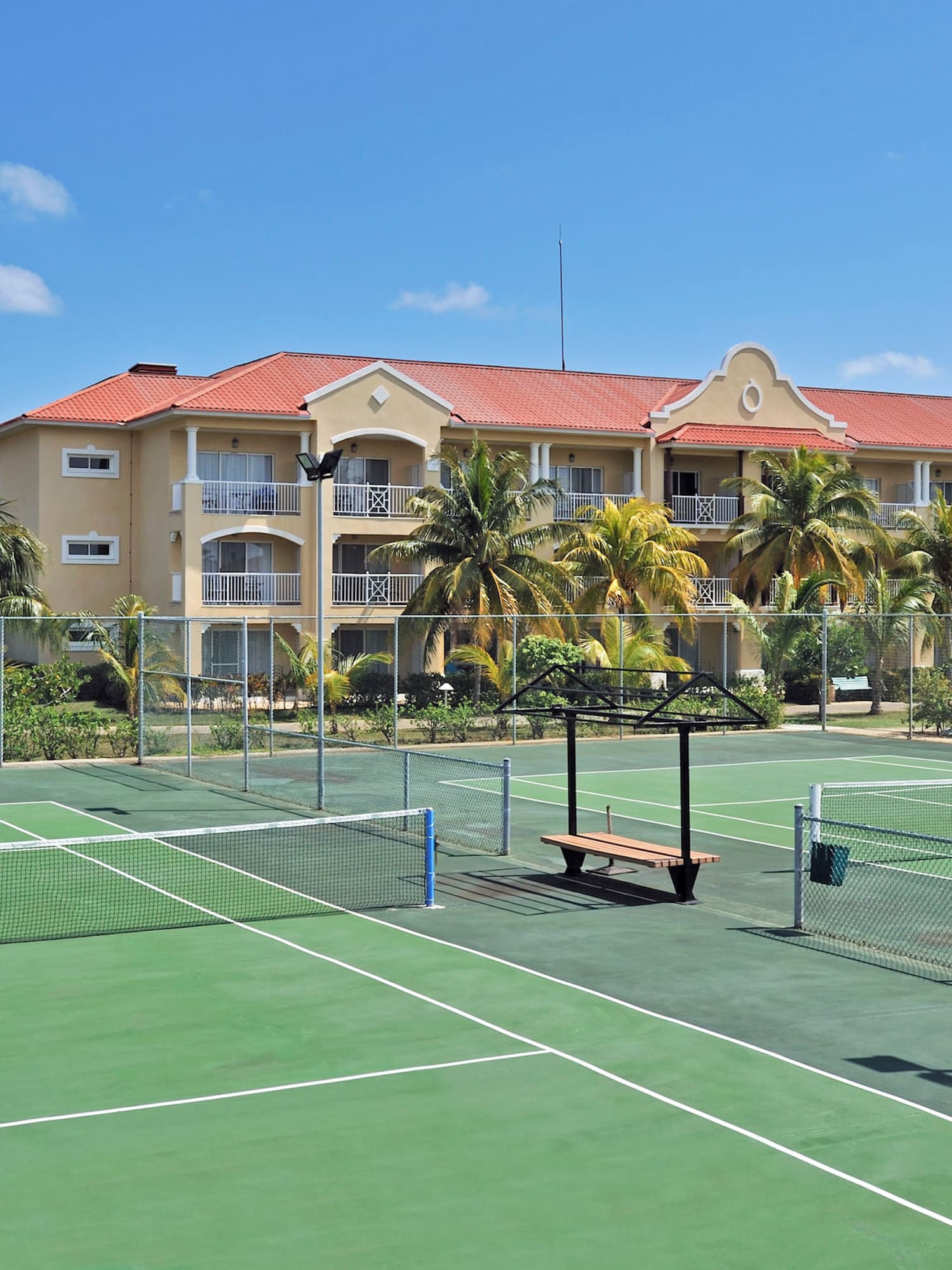 a tennis court with a building in the background