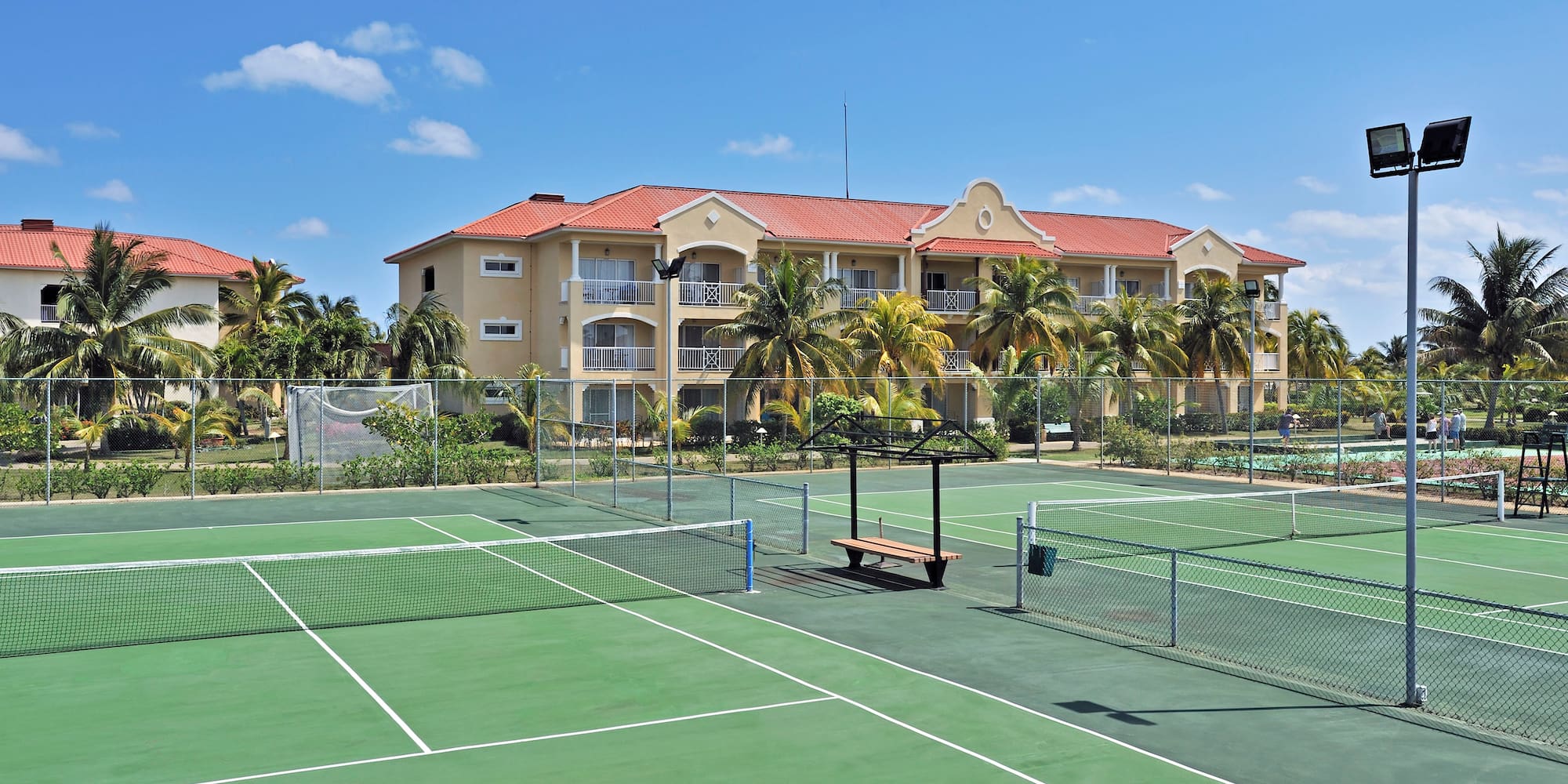 a tennis court with a building in the background