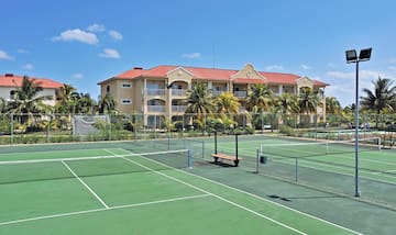 a tennis court with a building in the background
