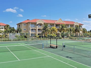 a tennis court with a building in the background
