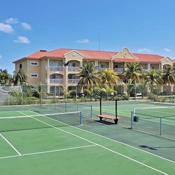 a tennis court with a building in the background