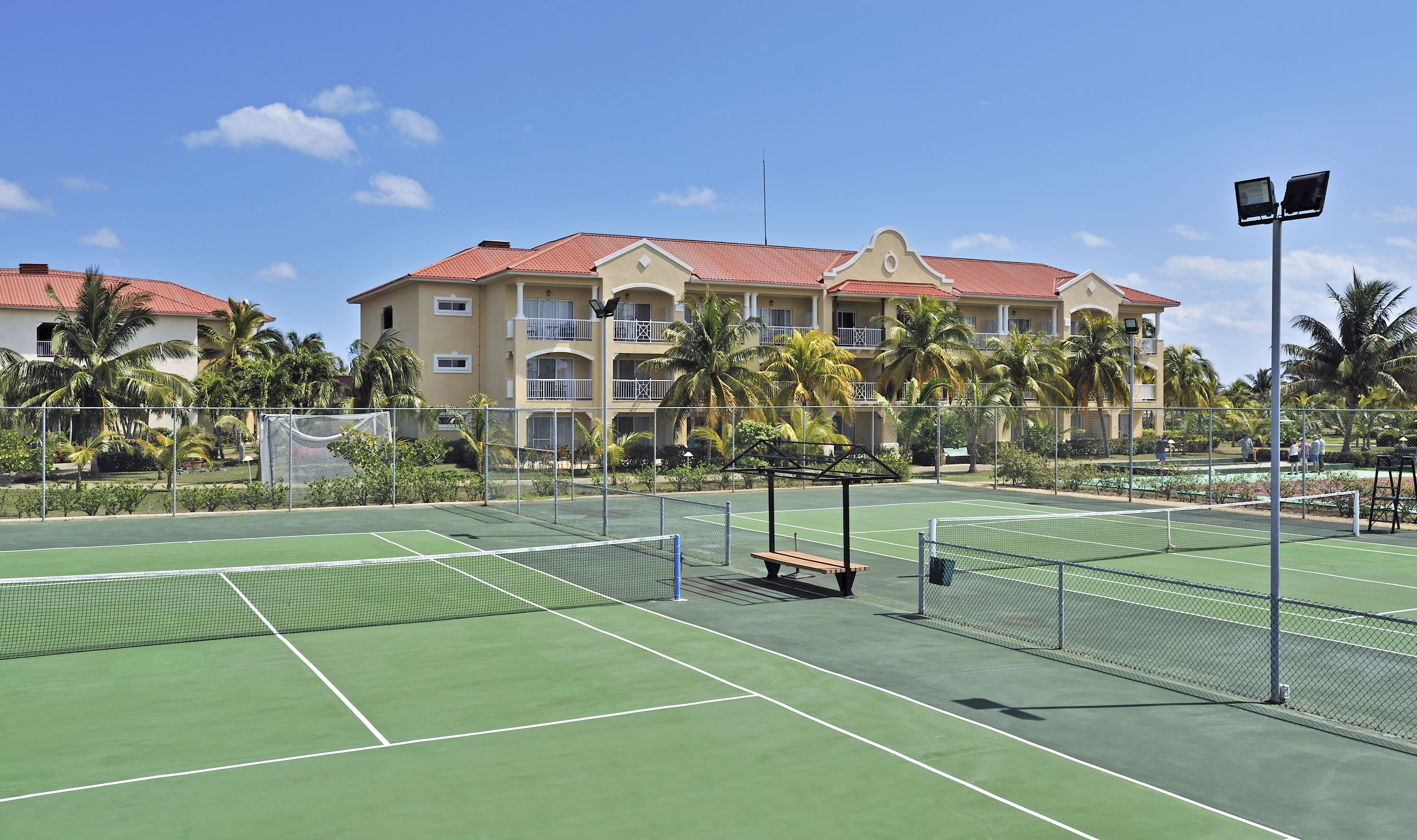 a tennis court with a building in the background