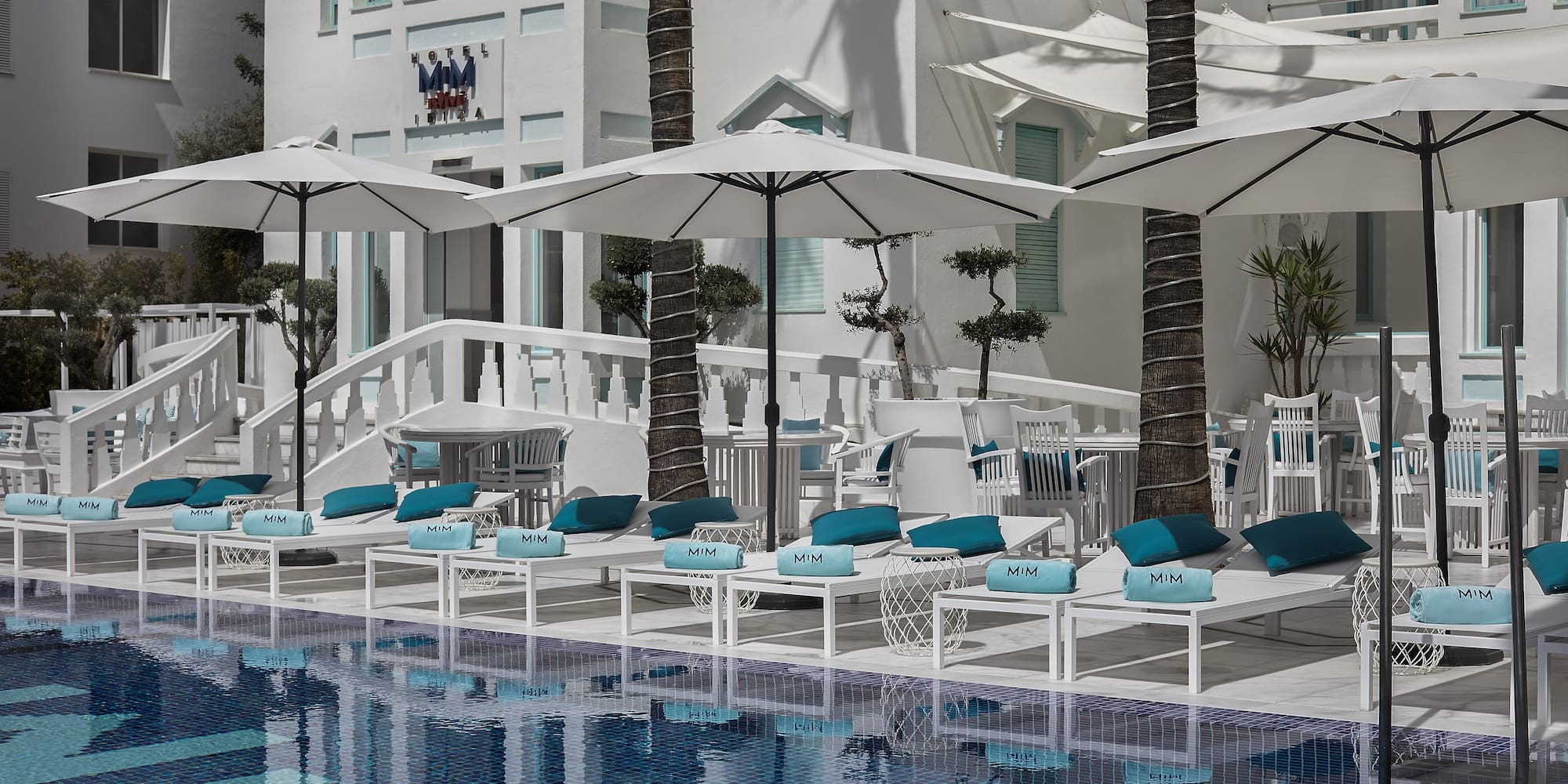 a pool with umbrellas and chairs