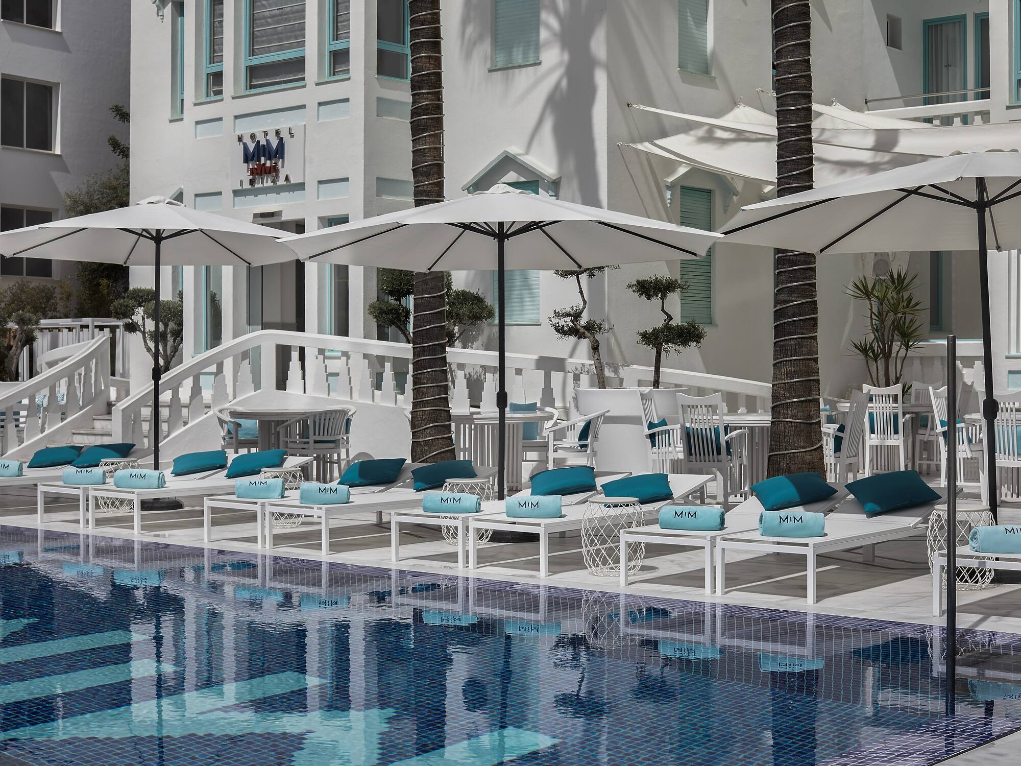 a pool with umbrellas and chairs