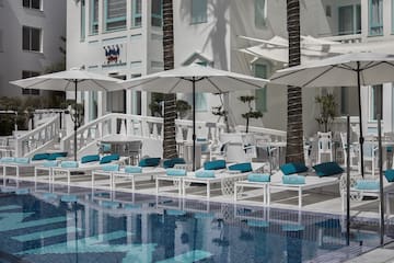 a pool with umbrellas and chairs