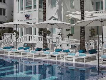 a pool with umbrellas and chairs