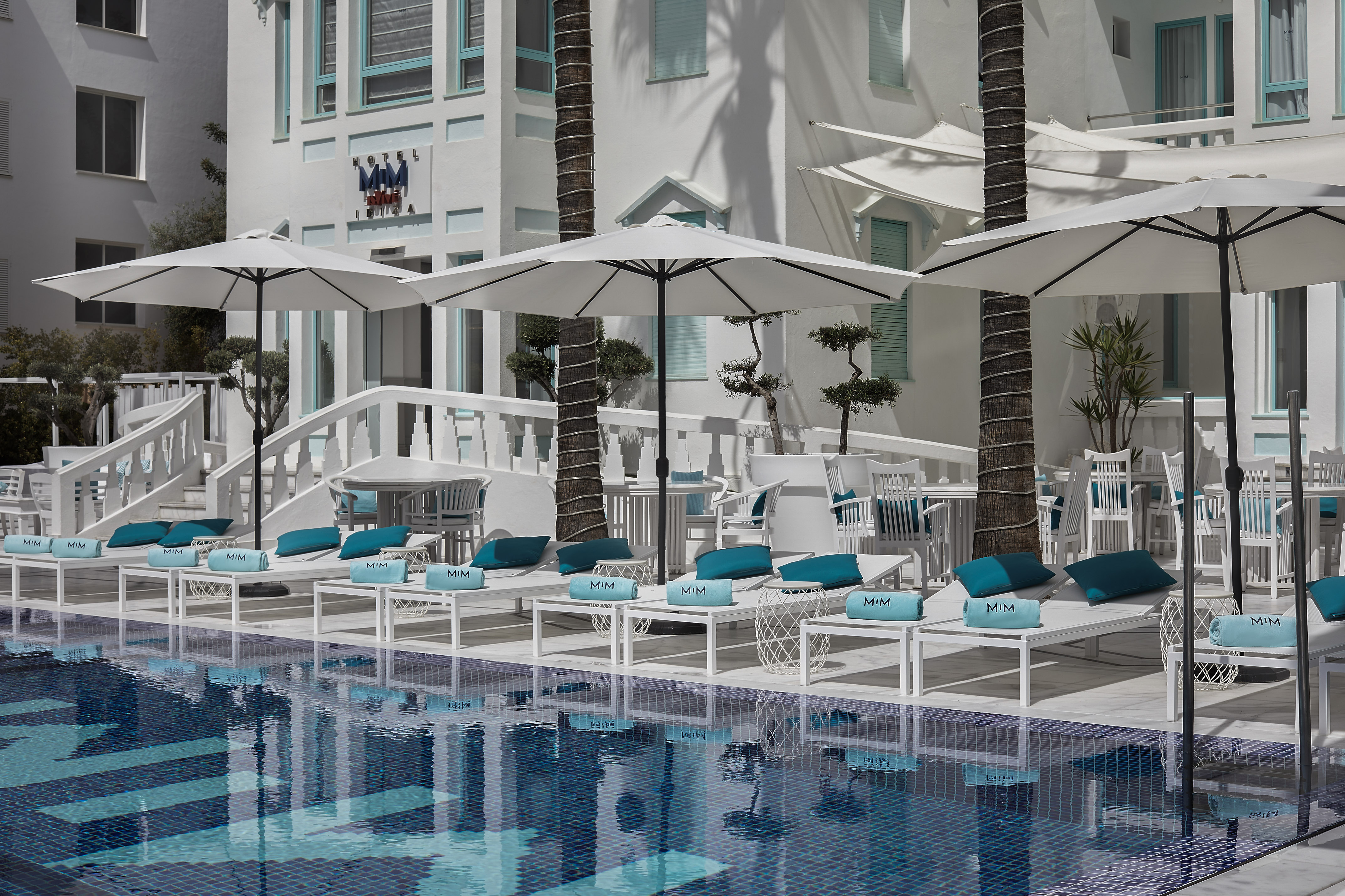 a pool with umbrellas and chairs