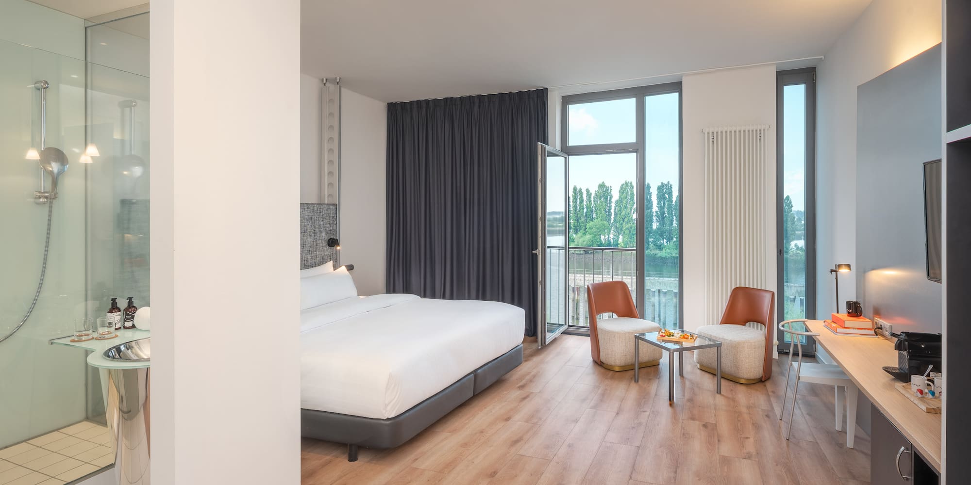 a room with a bed and chairs