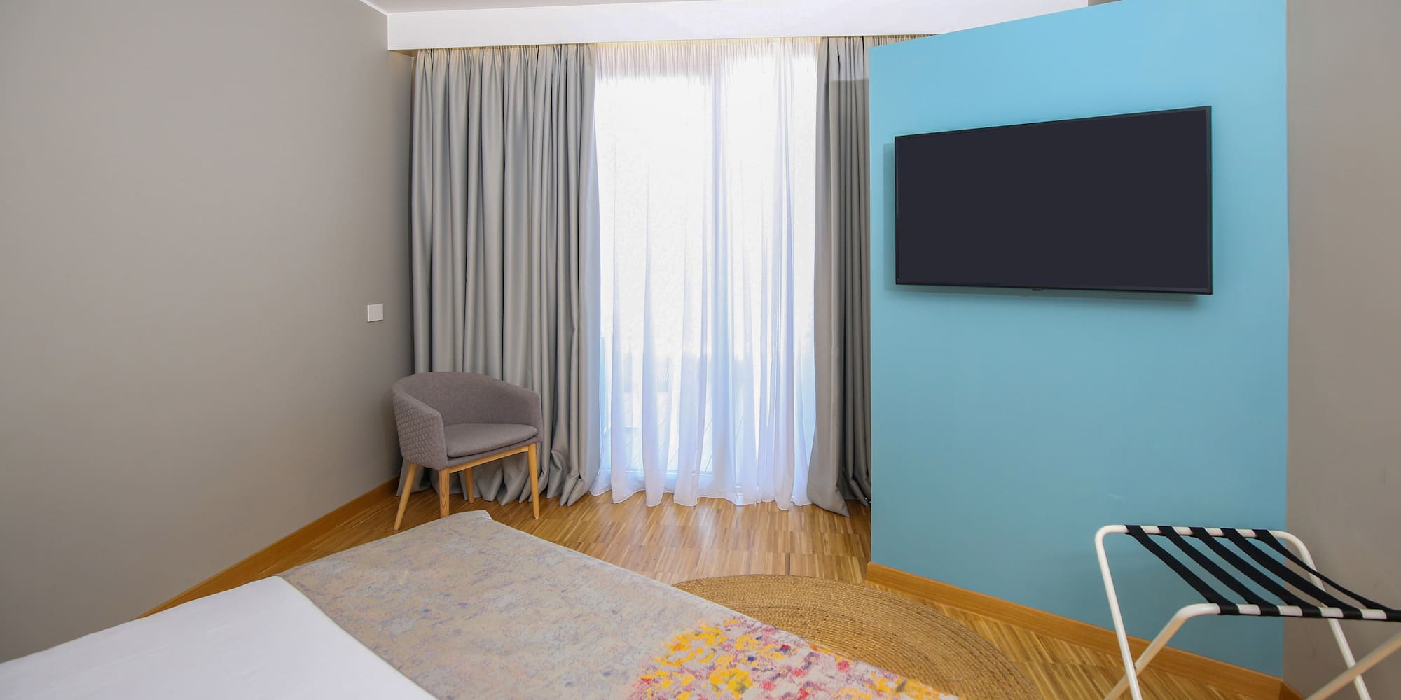 a room with a bed and a tv