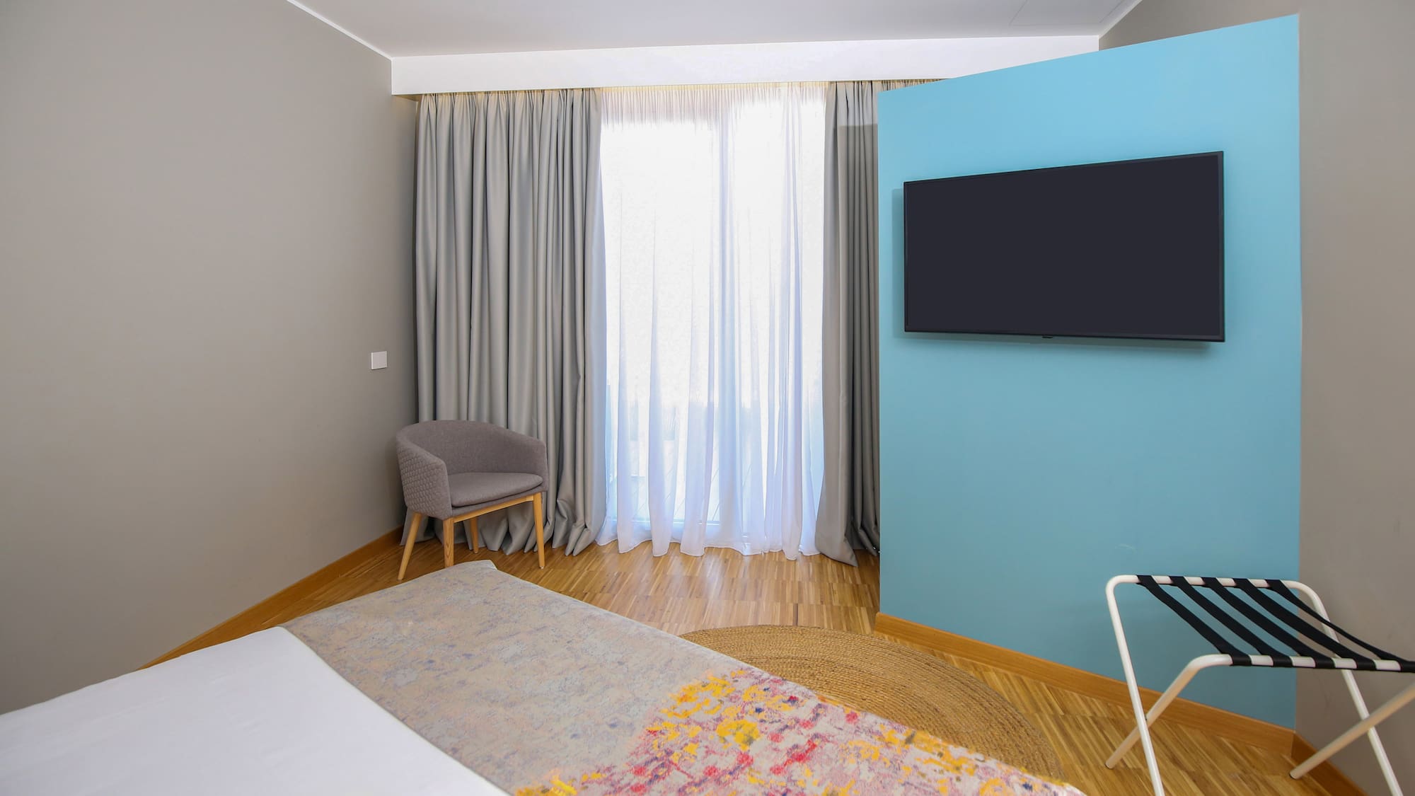 a room with a bed and a tv