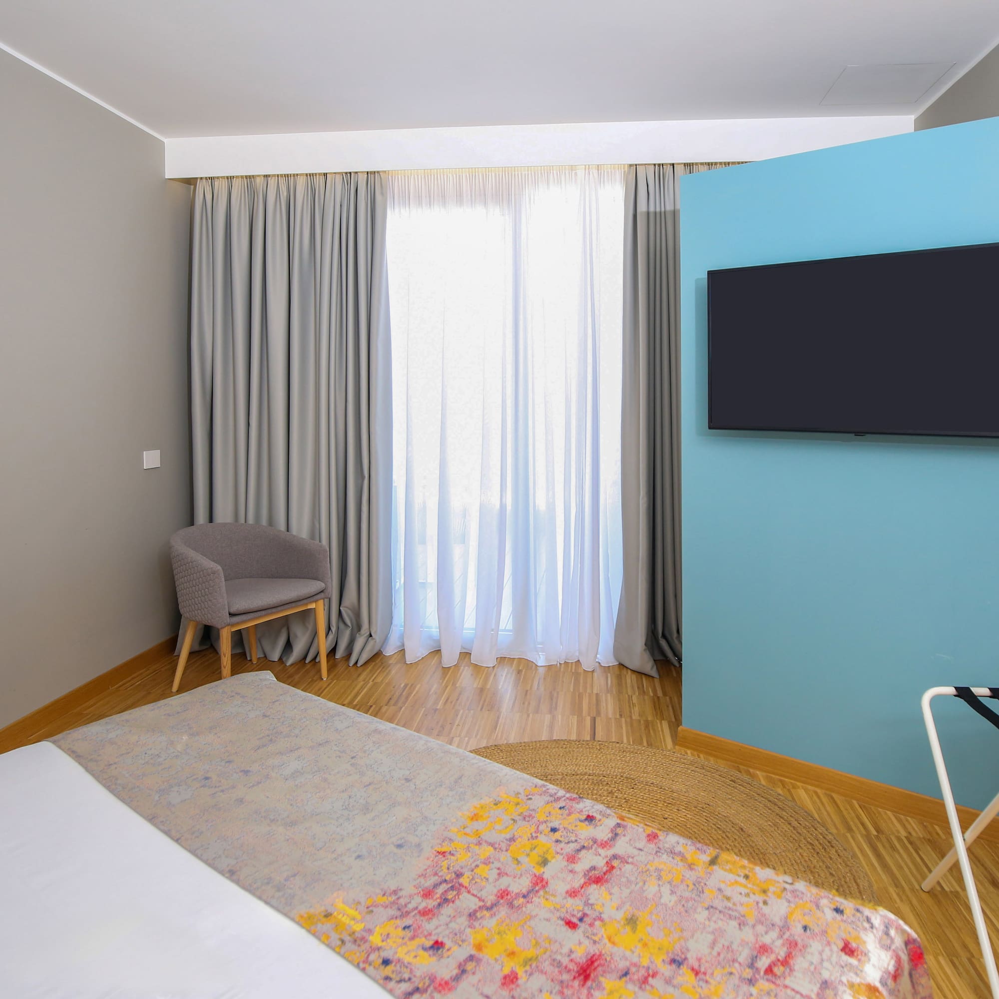 a room with a bed and a tv