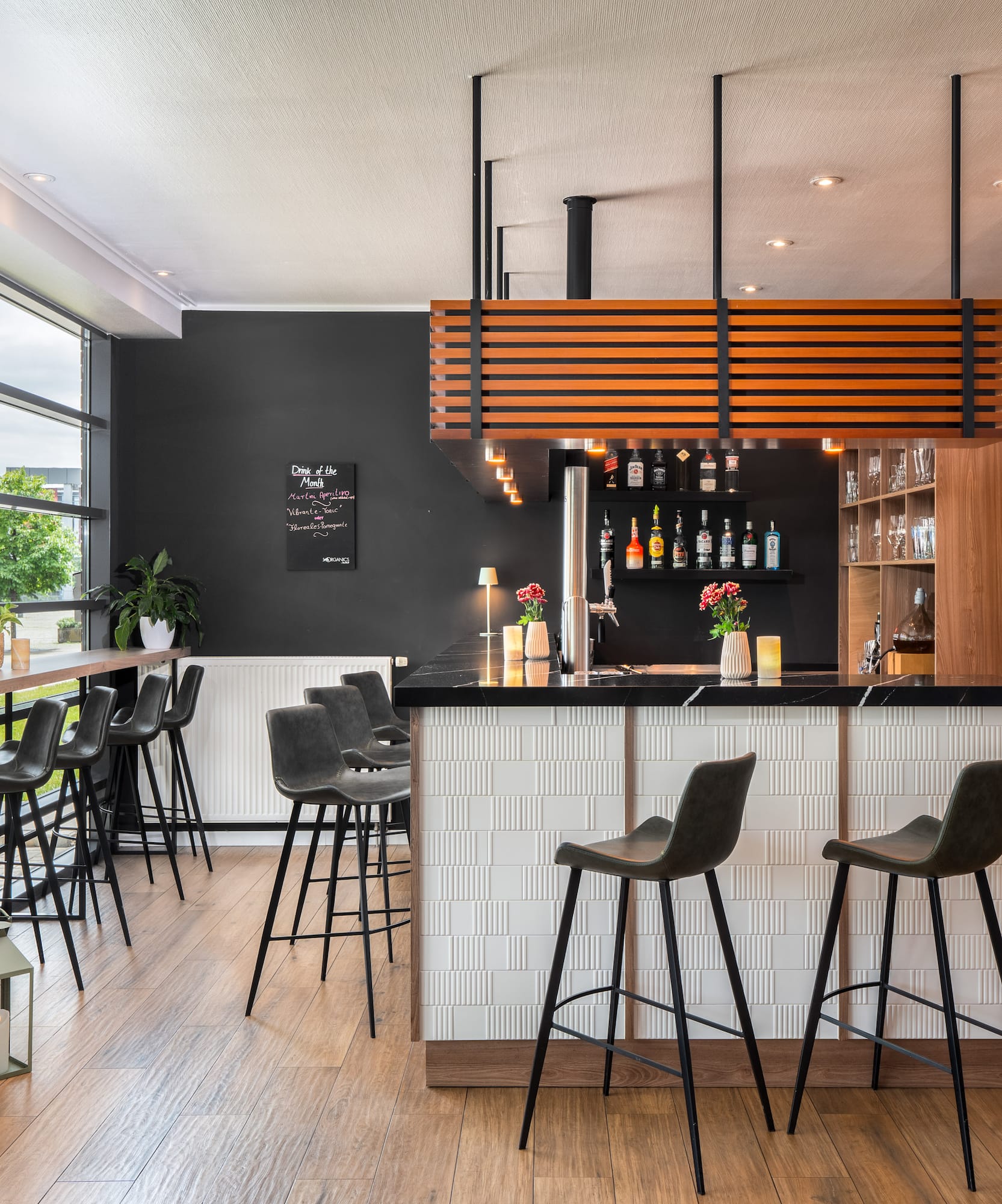 a bar with stools and a wood floor