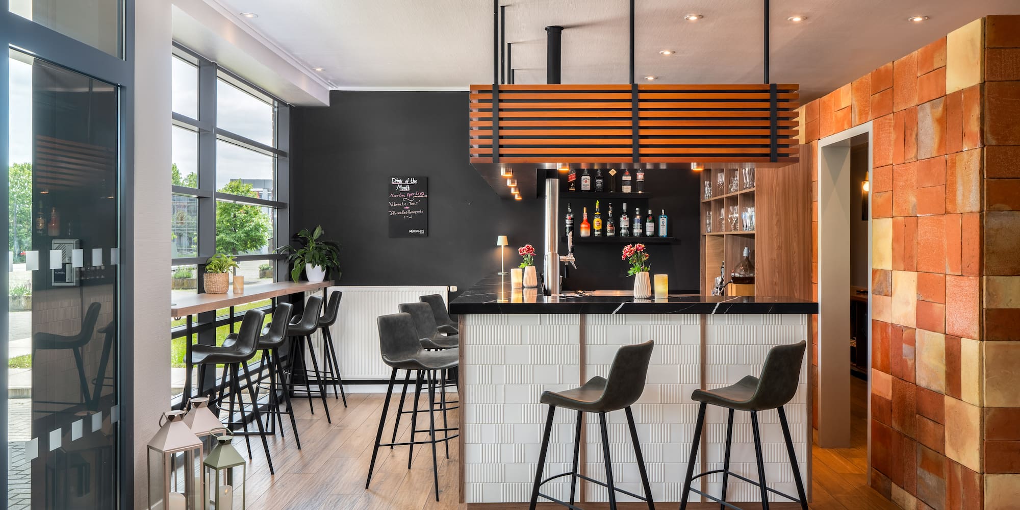 a bar with stools and a wood floor