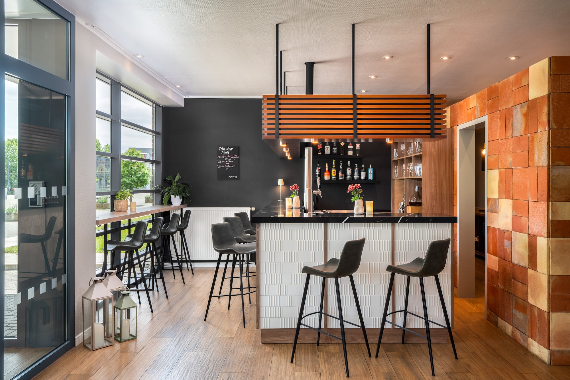 a bar with stools and a wood floor