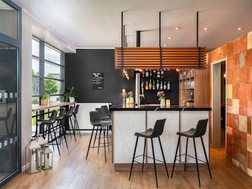 a bar with stools and a wood floor