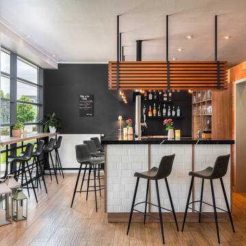 a bar with stools and a wood floor