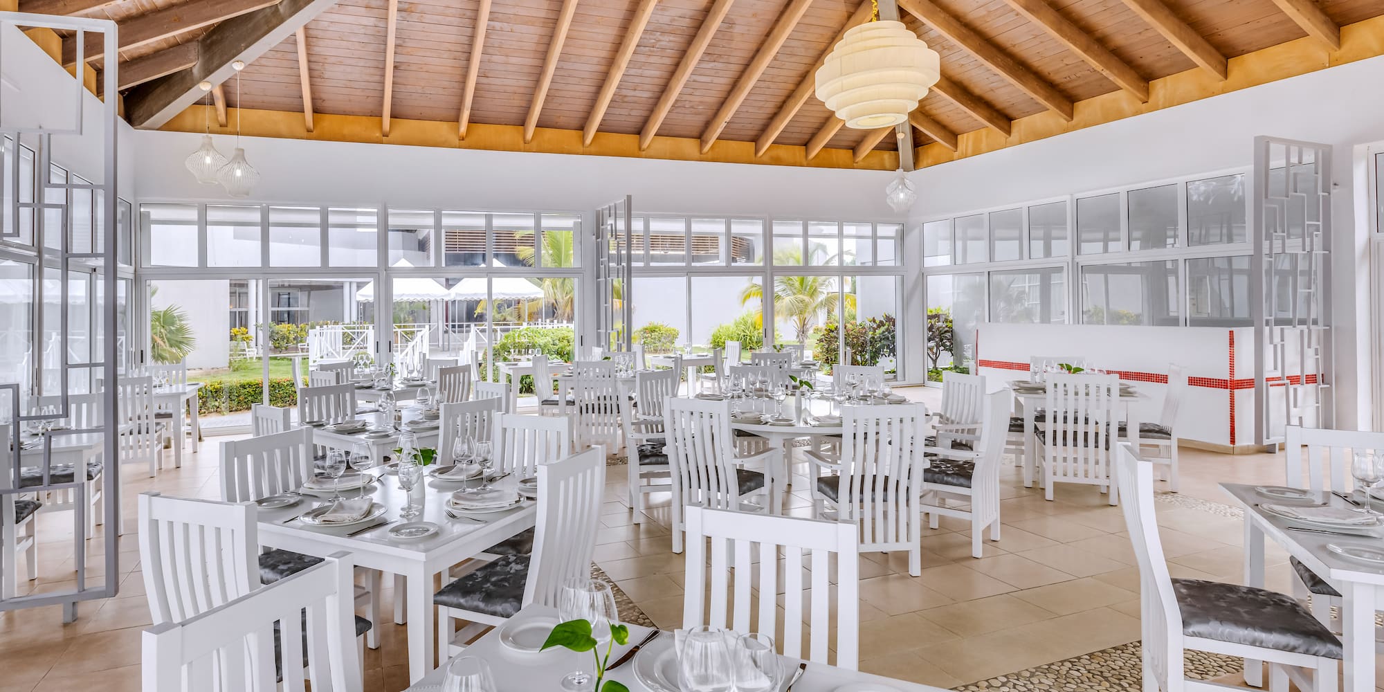 a room with white tables and chairs