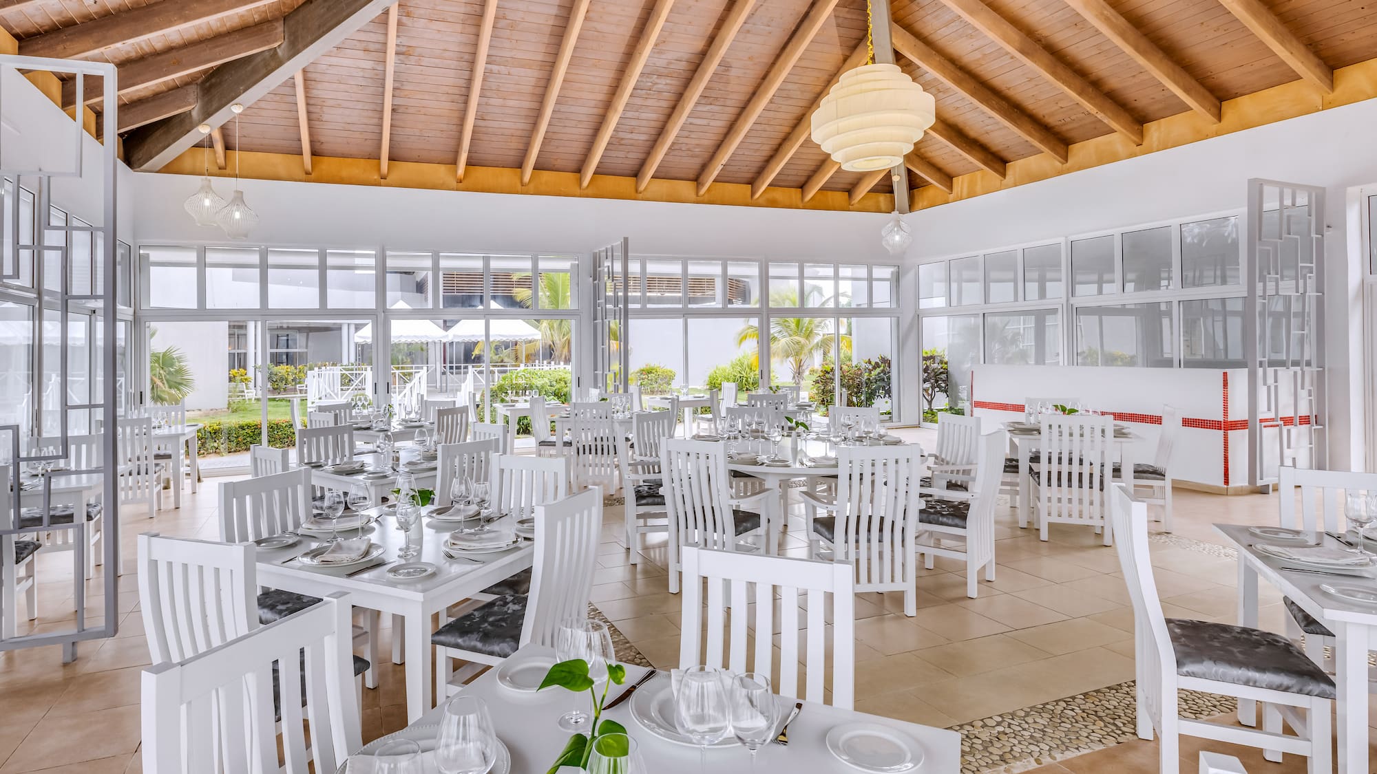 a room with white tables and chairs