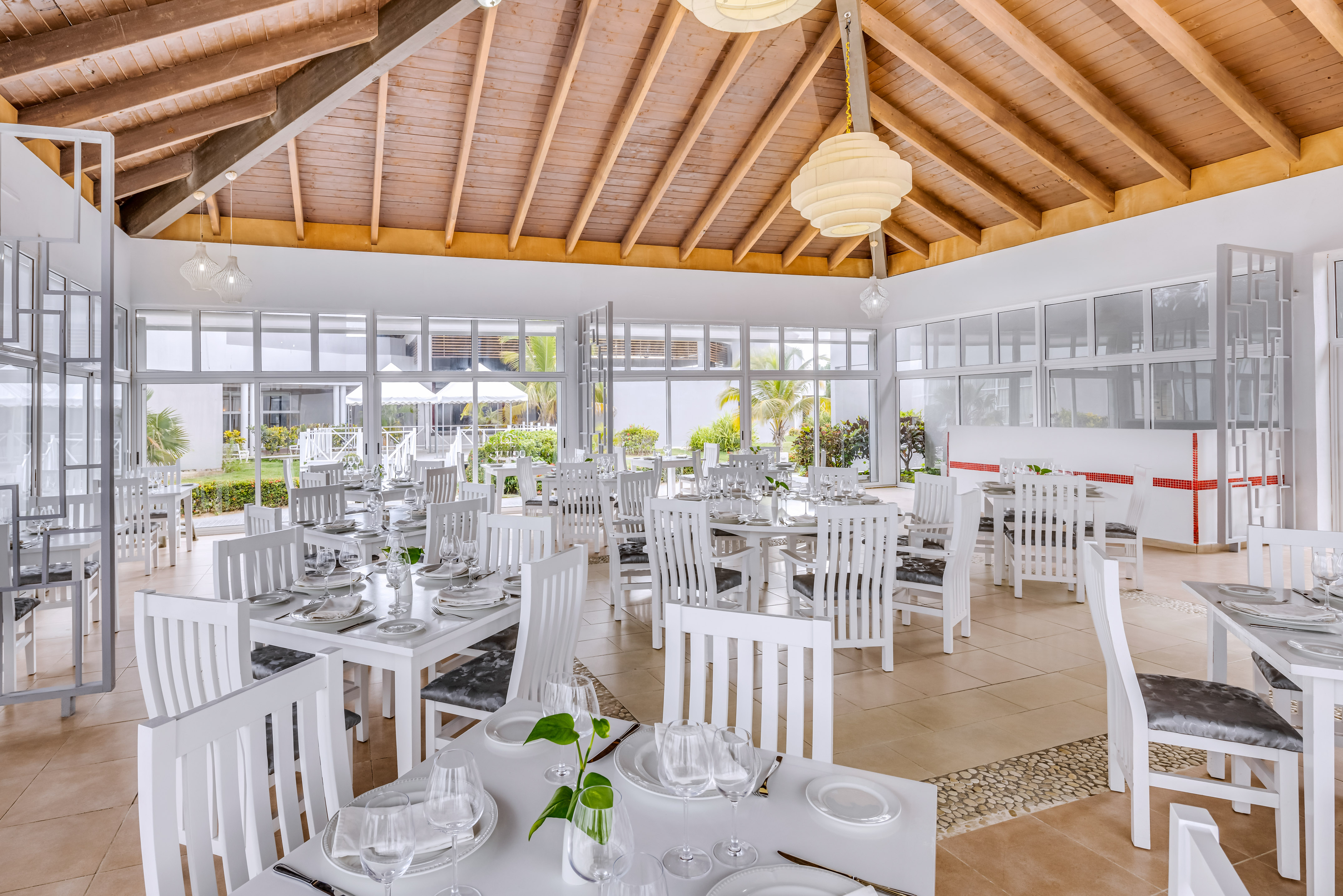 a room with white tables and chairs