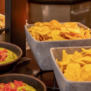 bowls of chips and dips in bowls