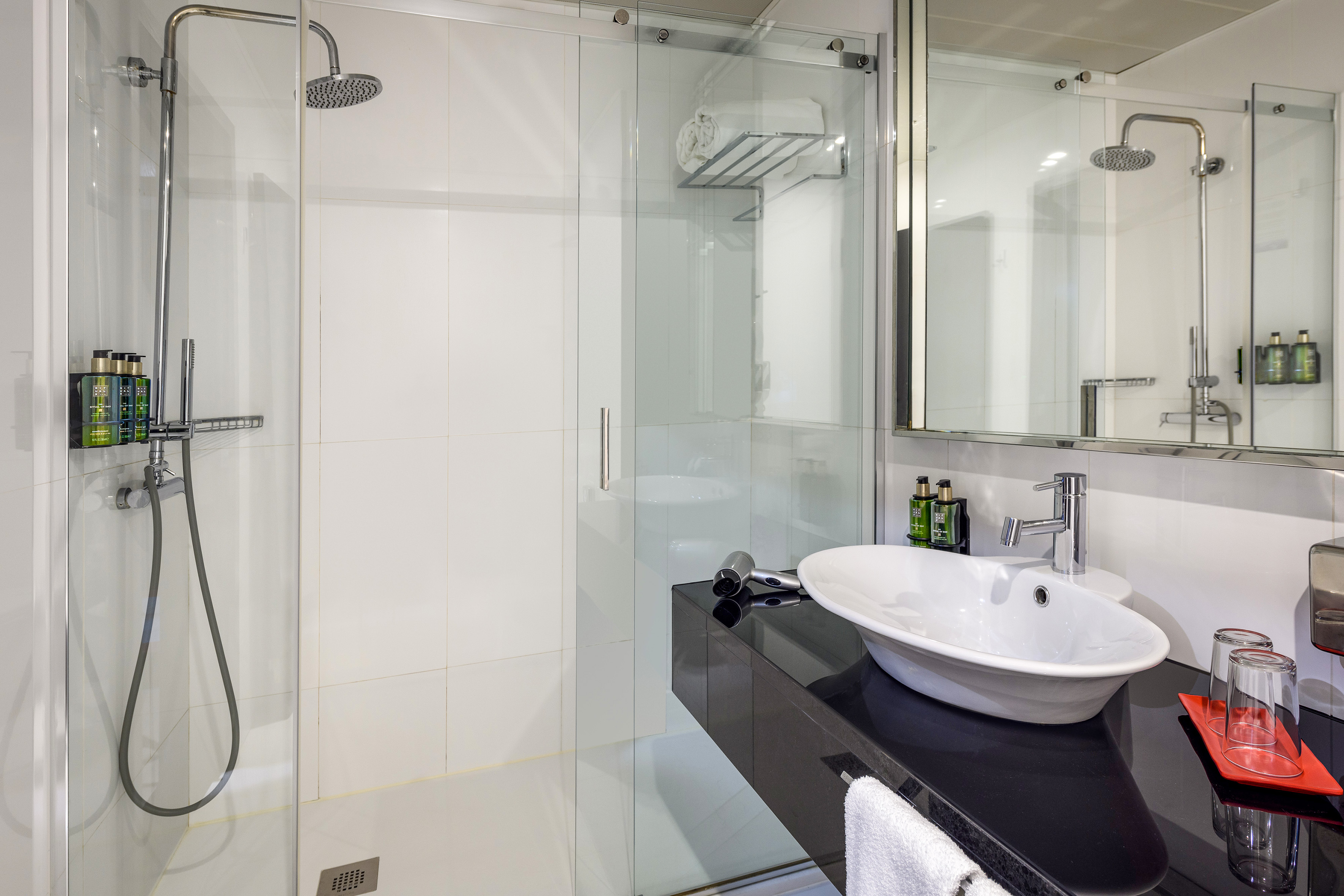 a bathroom with a shower and sink