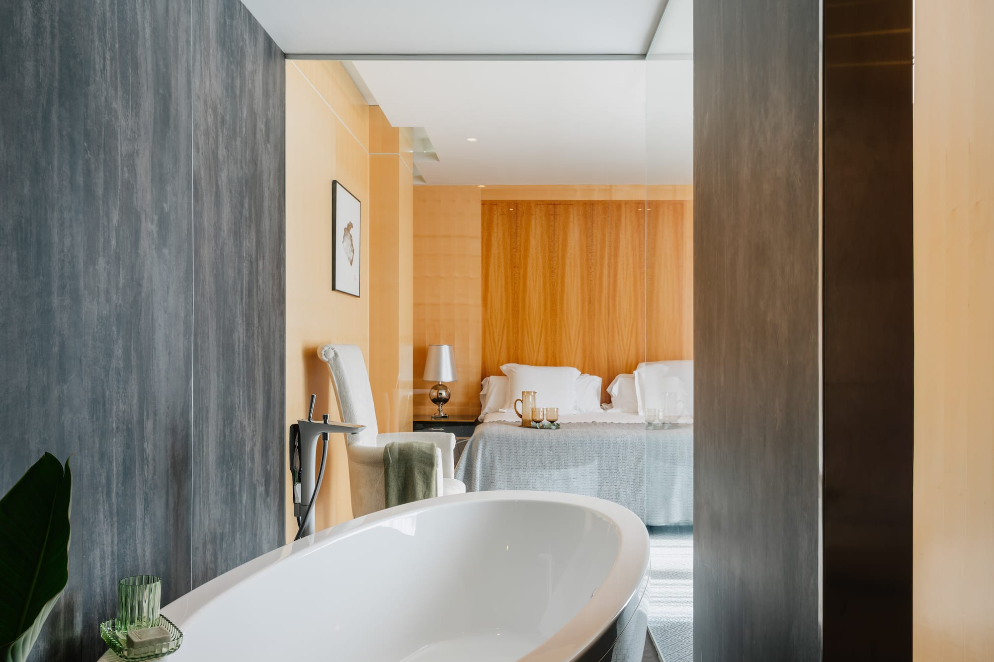 a bathroom with a bed and a bathtub