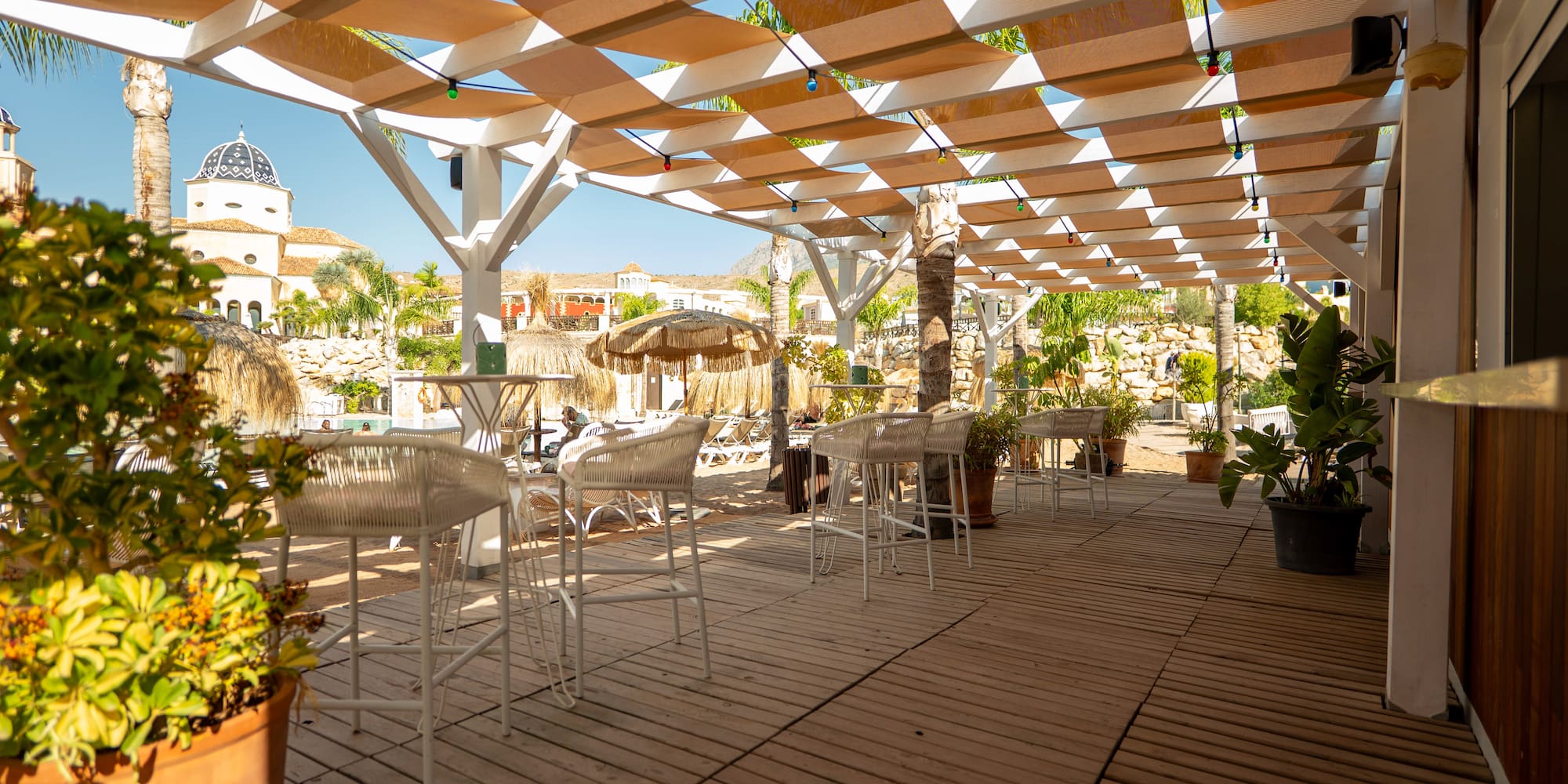 a patio with tables and chairs