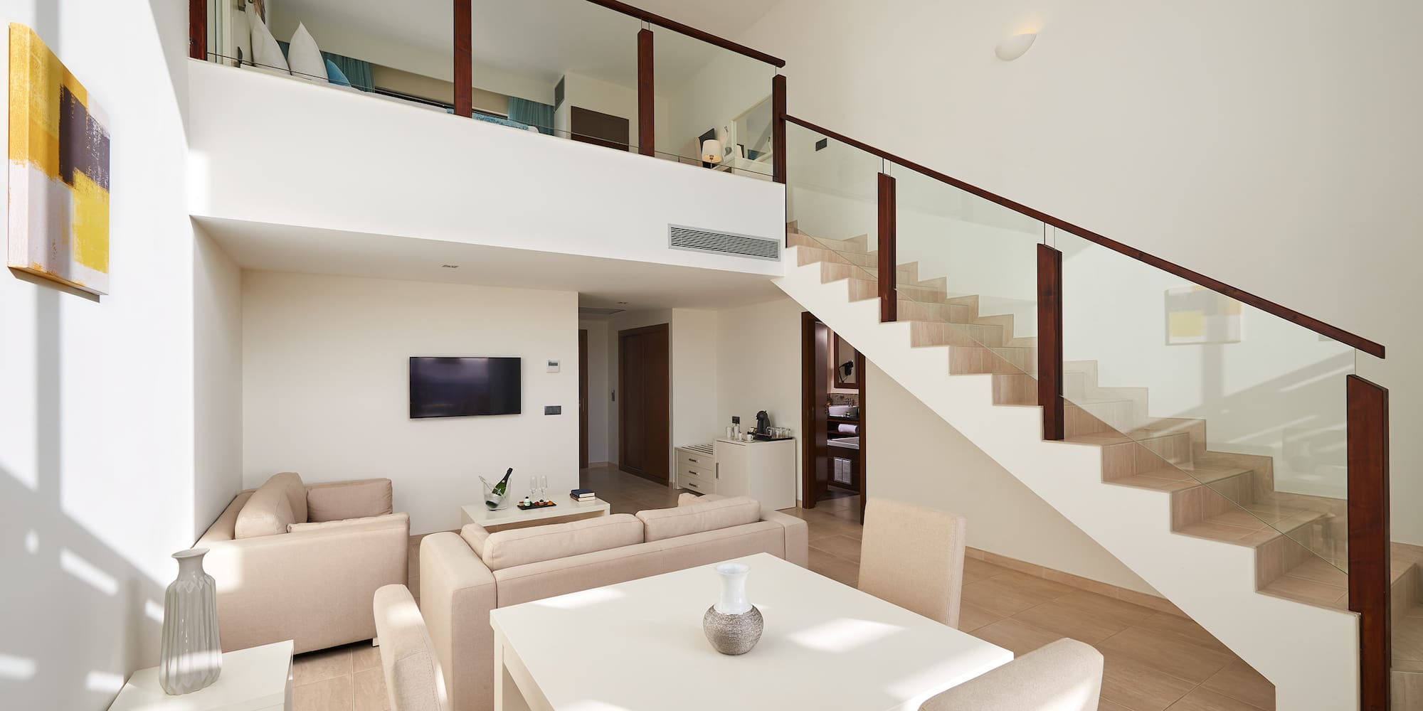 a living room with a staircase and a table