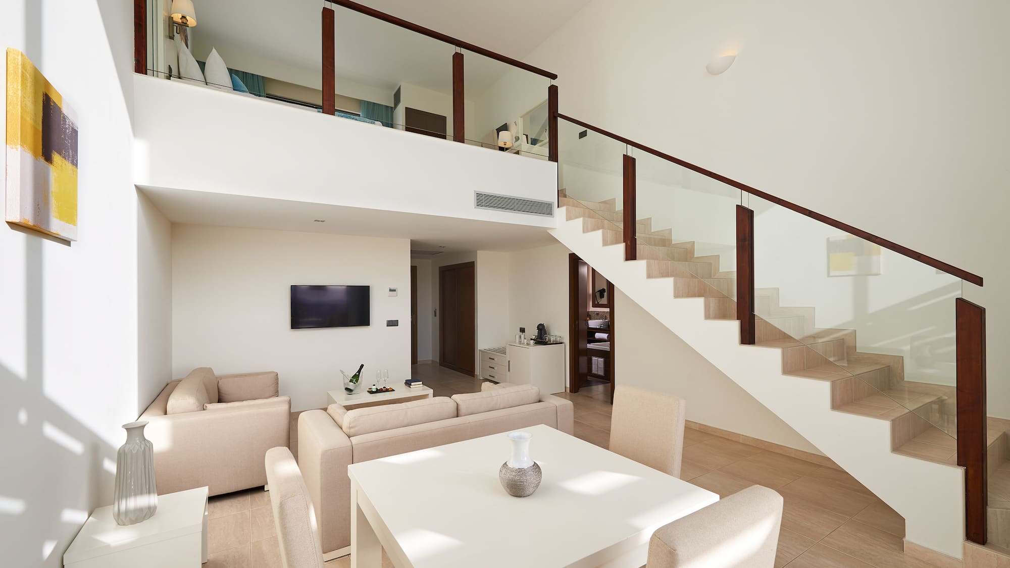 a living room with a staircase and a table