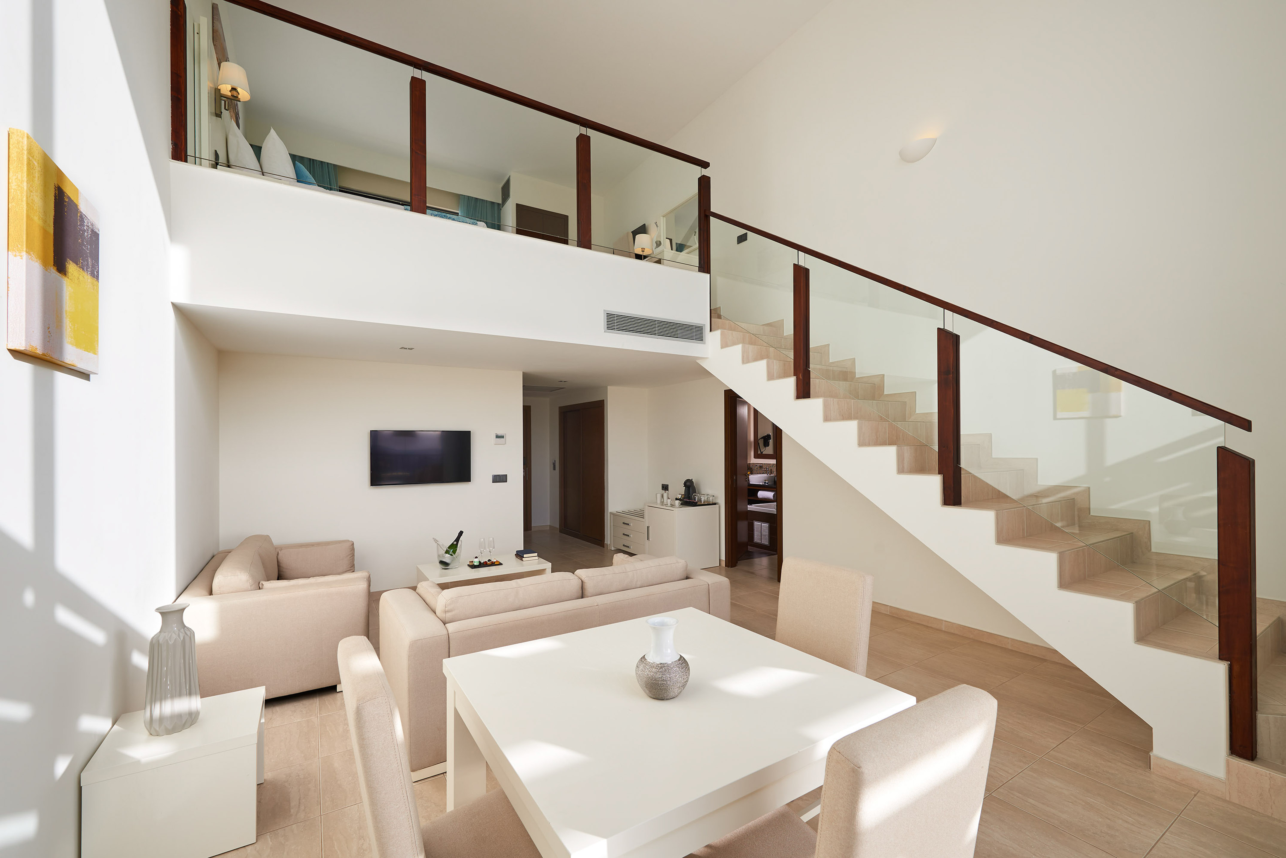a living room with a staircase and a table