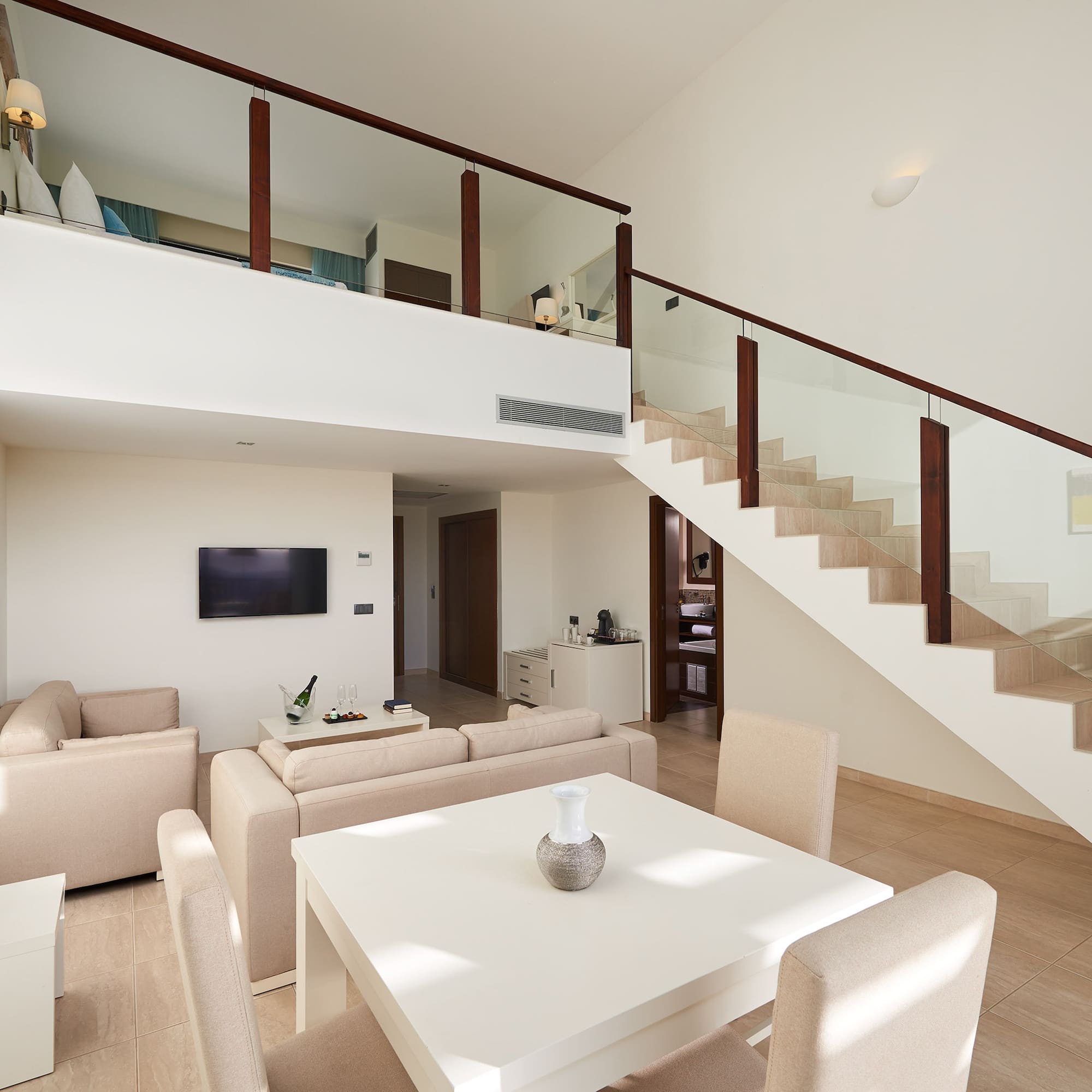 a living room with a staircase and a table